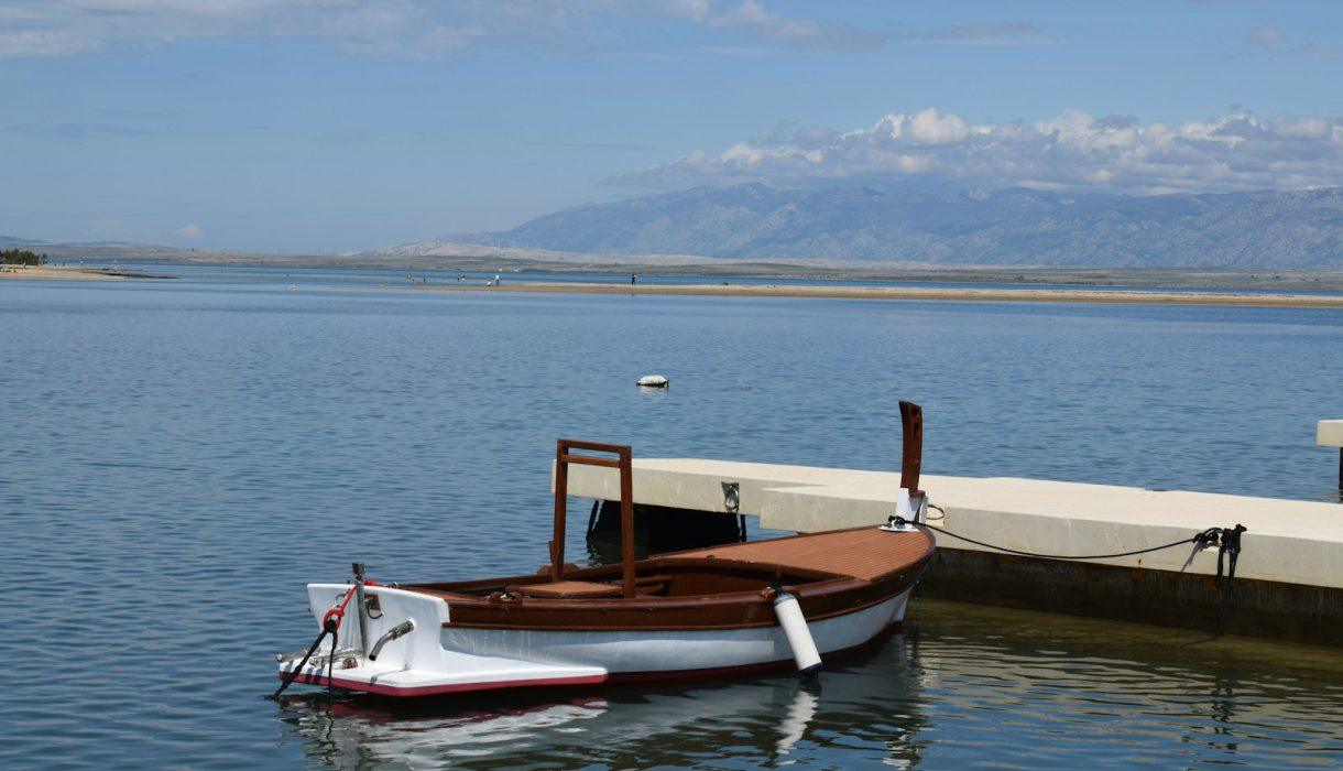 a small boat tied to a dock in the water