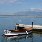 a small boat tied to a dock in the water