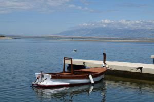 a small boat tied to a dock in the water